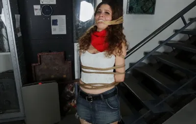 Mina –  Hot Cowgirl Mina Salome is bound to a post and gagged with rope